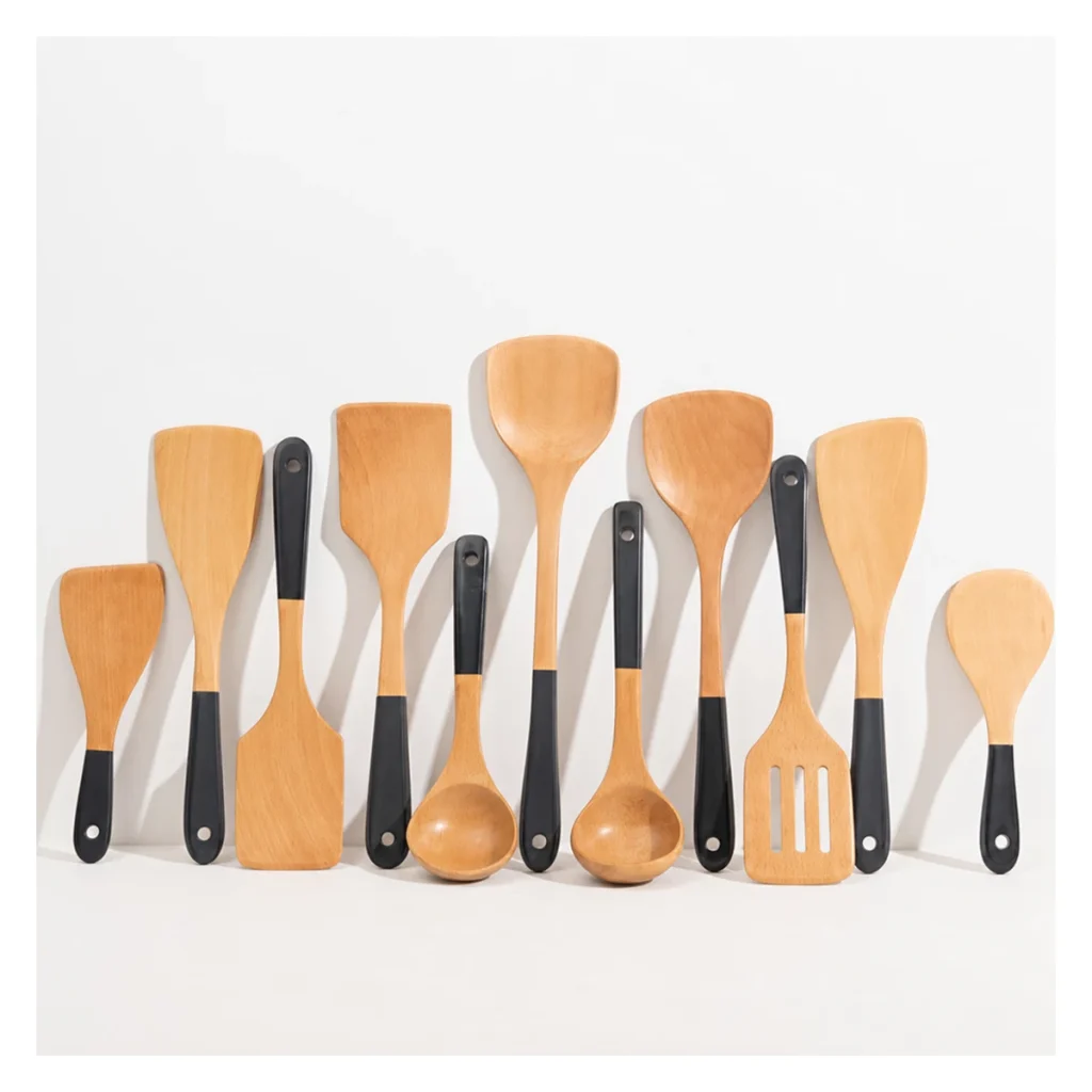 Wooden cooking utensils with lacquered handles on white background