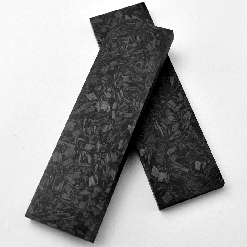 Carbon fiber handle material shown as paired black marbled scale blanks