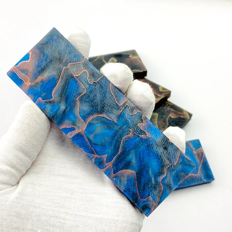 Blue copper mesh resin knife handle blank held for detail view