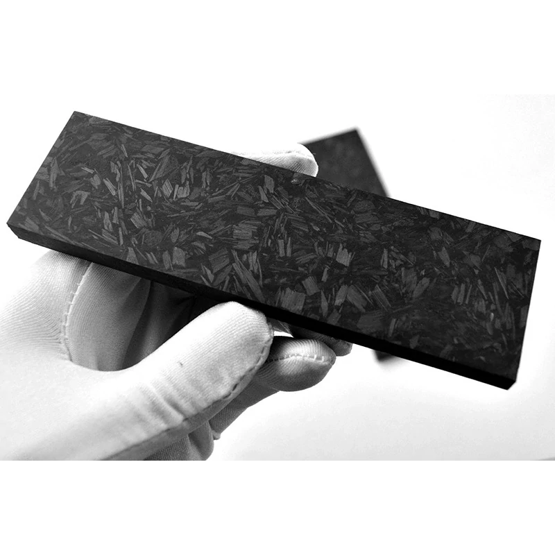 Carbon fiber handle material close-up with random chopped-fiber texture