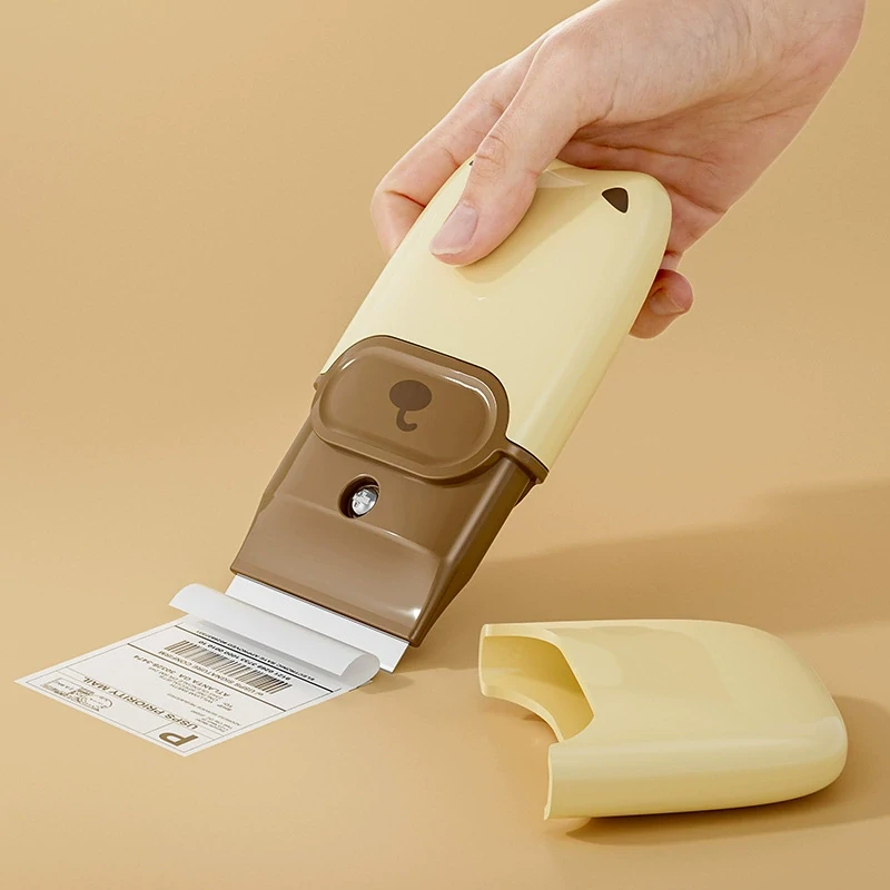 Handheld razor blade scraper removing an adhesive label
