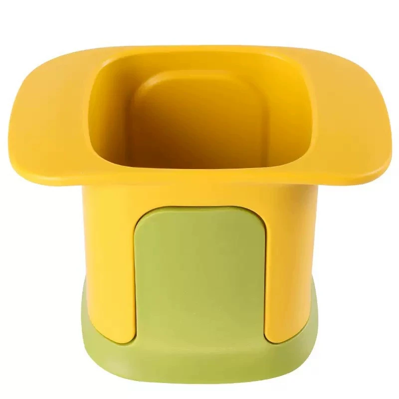Manual vegetable chopper in yellow and green on a white background