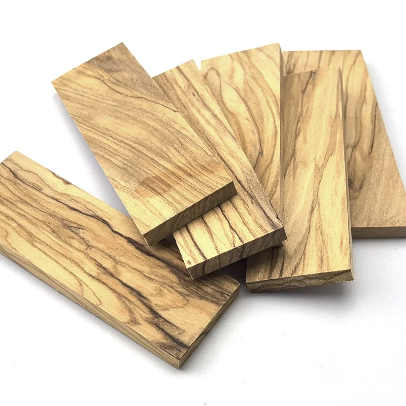 Natural olive wood handle scales showing warm color and dark grain