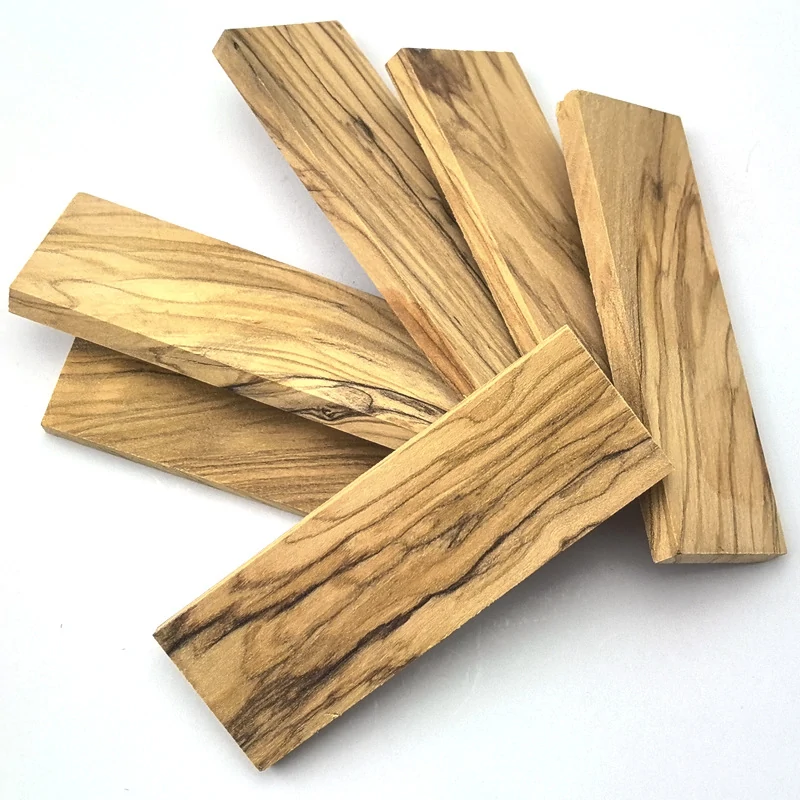 Knife handle blanks in natural olive wood with varied dark grain